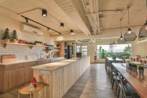 a large kitchen with wooden counters and a bar at Stray Birds Taichung Hostel in Taichung