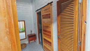 a room with a wooden door next to a wall at KALINDA HOMEY in Karimunjawa +60 photos