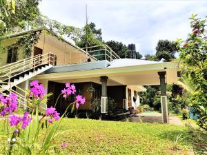 a house with pink flowers in the yard at EAST STAVANGER in Anaviratty