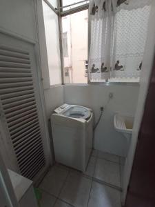 a small bathroom with a toilet and a sink at Cool and Cozy Apartment Copacabana in Rio de Janeiro