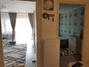 a room with a door leading to a bedroom at Manó apartman in Harkány