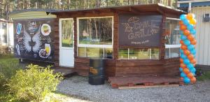 a small building with a sign on the side of it at Chill&Grill camping in Daugavpils