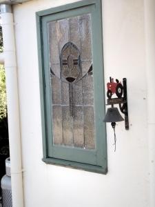 a door with a window with a bird on it at Friends in Harcourt North in Harcourt