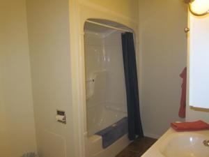 a bathroom with a shower and a sink and a toilet at Summers Country Inn in Digby