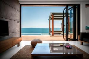 a living room with a view of the ocean at Jamahkiri Dive Resort & Spa in Koh Tao