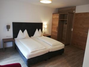 Postel nebo postele na pokoji v ubytování Hotel Posauner