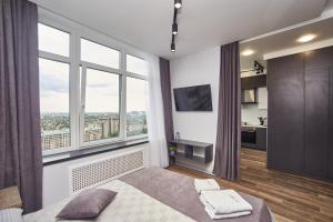 a bedroom with a bed and a large window at Board apart hotel in Odesa