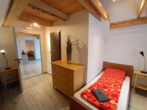 a bedroom with a bed and a dresser and a room at Tiptop Apartment & Outdoor Activities in Bovec