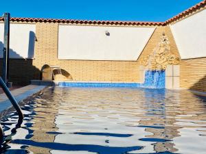 a pool of water in front of a building at La choza de Nolasco in Valdeganga