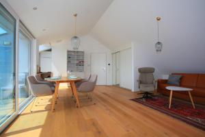 a living room with a table and chairs and a couch at See-Flair in Immenstaad am Bodensee