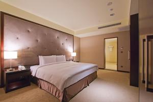 Postel nebo postele na pokoji v ubytování Lailai Hotel