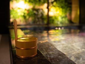 a cup sitting on top of a table next to a pool at Super Hotel Nagoya Shinkansenguchi in Nagoya