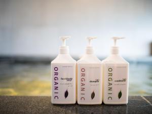 three bottles of lotion sitting on a counter at Super Hotel Nagoya Shinkansenguchi in Nagoya