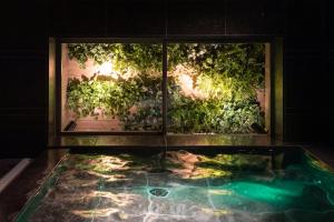 a room with a window and a pool of water at Super Hotel Nagoya Shinkansenguchi in Nagoya