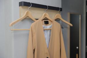 a coat hanging on a rack in a room at Super Hotel Nagoya Shinkansenguchi in Nagoya