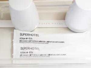 a pile of white styrofoam cups on a shelf at Super Hotel Nagoya Shinkansenguchi in Nagoya
