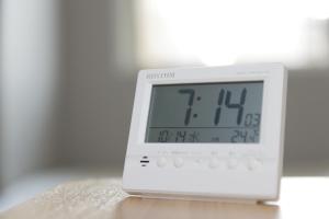 an alarm clock sitting on top of a table at Super Hotel Nagoya Shinkansenguchi in Nagoya