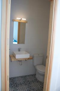 a bathroom with a sink and a toilet at Entheos in Lerín +37 photos