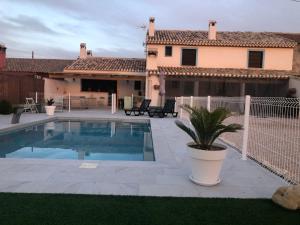 a house with a swimming pool in front of a house at Casa Chirreas in Caravaca de la Cruz
