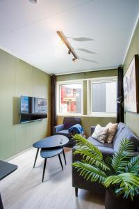 a living room with a couch and a table at Easy Home Apartments in Hammerfest