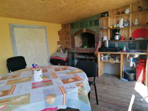 a kitchen with a table with a table cloth on it at Saulespuķe in Ventspils