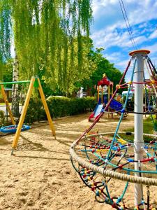 a playground with many different colored swings at Przystań Biskupińska in Biskupin