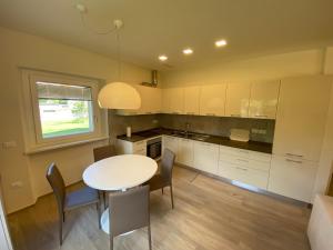 a kitchen with a table and chairs and a window at Chaligne Suite in Aosta