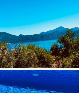 two pictures of a lake with mountains in the background at Defne Residence Selimiye in Marmaris