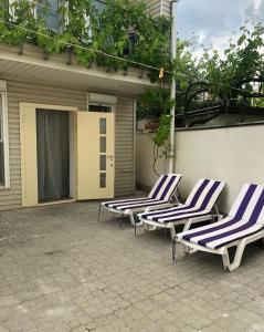 a group of lounge chairs sitting on a patio at Котедж біля моря in Odesa