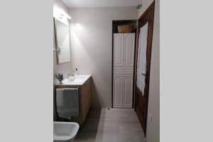 a bathroom with a sink and a toilet and a mirror at Apartamento Ceclavín in Cáceres +23 photos