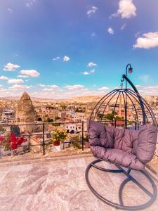 a purple couch sitting on top of a balcony with a view at Arinna Cappadocia in Goreme