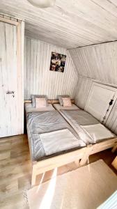 A bed or beds in a room at Napraforgó Vendégház