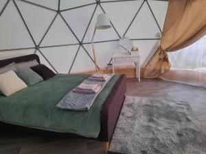 a bedroom with a bed in a tent at Glempings Velo Latgale in Izvalta