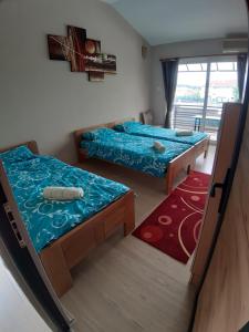 a room with two beds and a window at Goka apartments in Gevgelija