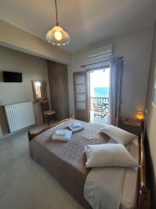a bedroom with a bed with a view of the ocean at Irida Studios in Agios Ioannis Pelio