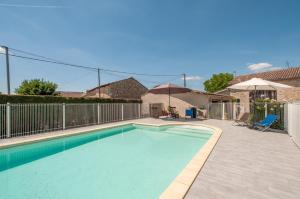 a swimming pool in a yard with a fence at Gîte Laulerie in Saint-Méard-de-Gurçon