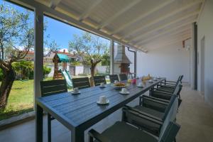 a blue table and chairs on a patio at Relaxing villa Mala vala in Fažana