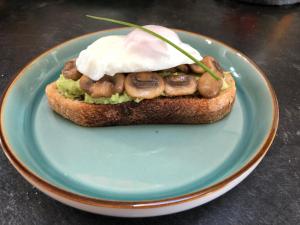 a piece of bread with mushrooms and cream on a plate at Dalgreine Guest House in Blair Atholl