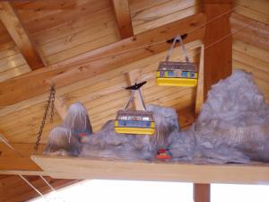 deux trains de jouets suspendus au plafond d’une cabine dans l'établissement Affittacamere De Charme Jour Et Nuit, à Torgnon