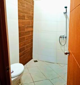 a bathroom with a toilet and a shower at Villa Lembang Syariah near park & Zoo in Lembang