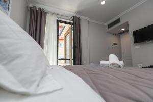 Postel nebo postele na pokoji v ubytování Hotel Peroni