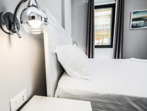 Postel nebo postele na pokoji v ubytování Hotel Peroni