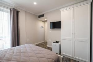 Postel nebo postele na pokoji v ubytování Hotel Peroni