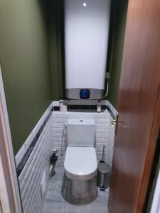 une petite salle de bain avec des toilettes blanches avec une fenêtre dans l'établissement La Croisette, à Mont-de-Lans