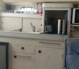 a kitchen with a sink and a microwave at Sea Guesthouse in Canet-en-Roussillon