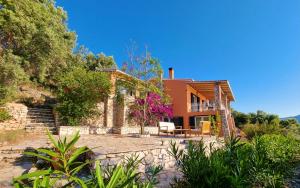 an exterior view of a house with a patio at Villa Nautique - Waterfront in Sivota