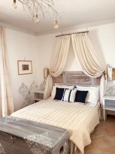 a bedroom with a large bed with curtains at Casa Caterina Lake View Holidays Apartments in Peschiera del Garda