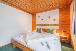 a bedroom with a bed in a wooden room at Panoramahotel Stocker in Pruggern