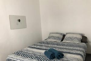 a small bedroom with a bed with blue sheets at M4 Cool Terrace. 1 min to metro. 15 min to center in Esplugues de Llobregat +27 photos