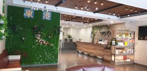 a restaurant with a green door and a counter at Tapeng Bay Holiday Hotel in Donggang